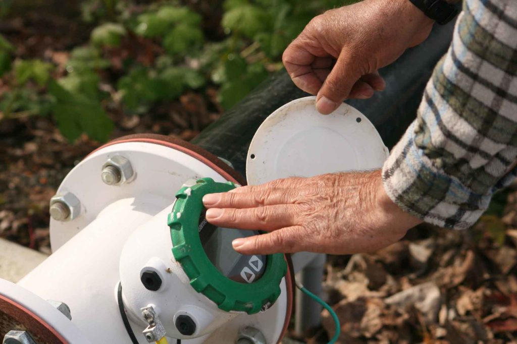 Jeff Newton inspects a flow meter.